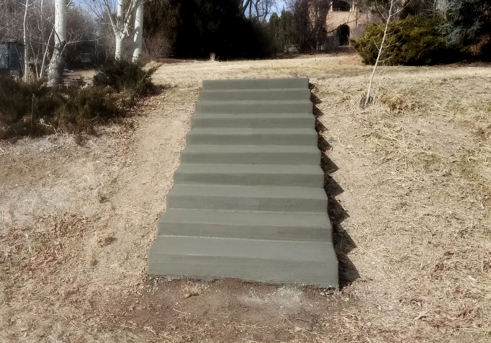 concrete_steps_from_open_space_up_to_back_yard